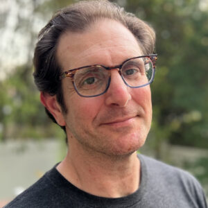 Dan Brown, a white man with glasses and receding hairline
