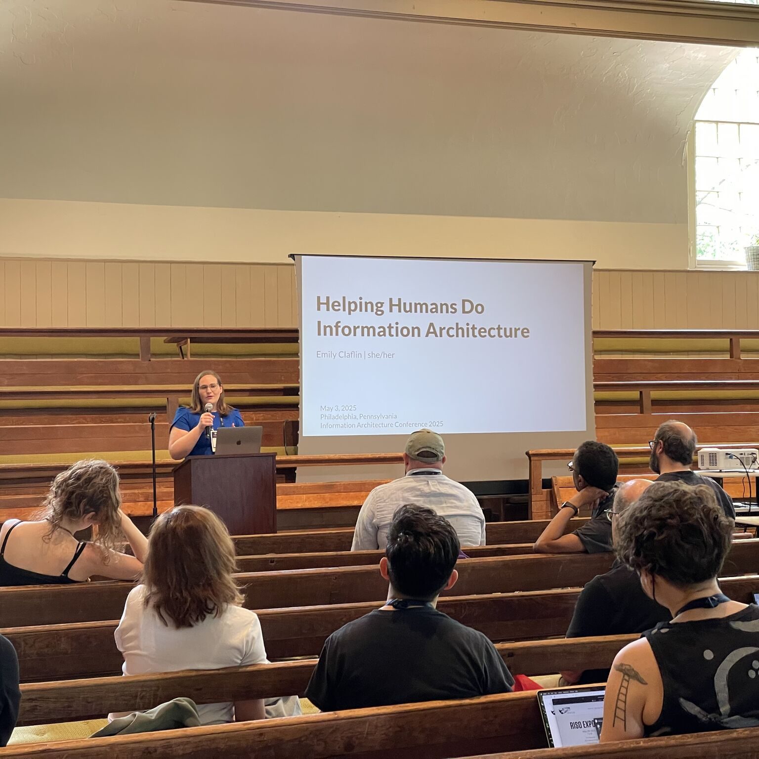 People sitting and watching a presenter at IAC25.